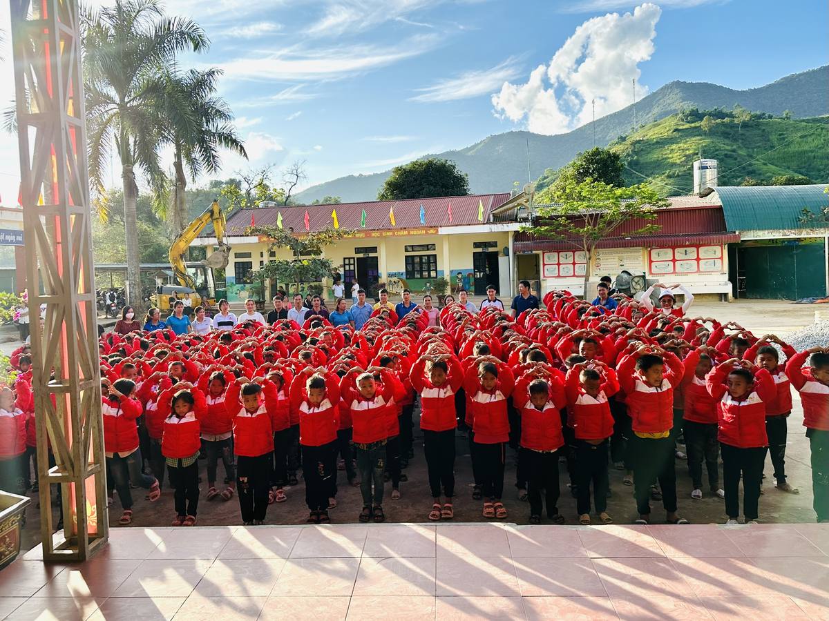 A schoolyard of children wearing red winter coats